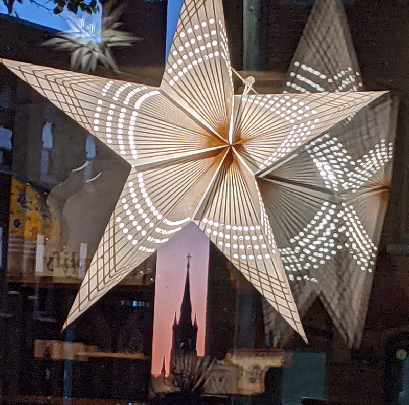 Lit star decoration in window